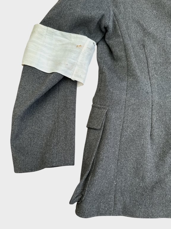 DRK (Deutsches Rotes Kreuz)  Vorhelfer service tunic with original insignia and armband.