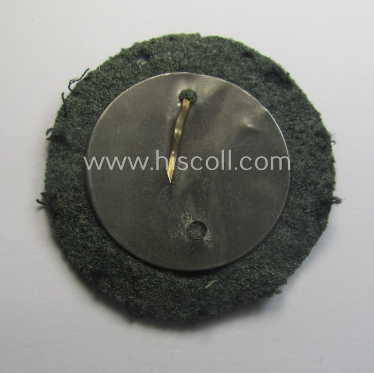 WH (Heeres o. Waffen-SS) so-called: 'Kraftfahrbewährungs-Abzeichen in Bronze' (or: bronze-class drivers'-proficiency-badge) that comes mounted onto its piece of field-grey-coloured wool as most certainly issued- and/or clearly worn, condition