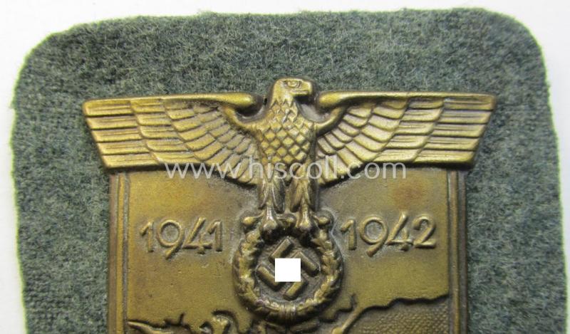 Attractive, WH (Heeres o. Waffen-SS) 'Krim'-campaign-shield that comes mounted onto its original, field-grey-coloured 'backing' and that comes in an issued-, minimally worn and/or (I deem) carefully tunic-removed-, condition