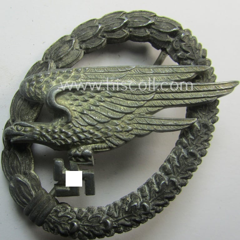 Zinc- (ie. 'Feinzink'-) based version of a WH (Luftwaffe) 'Fallschirmschützen-Abzeichen' (being a maker-marked, 'Type D'-pattern example as was produced by the 'G.H. Osang'-company)