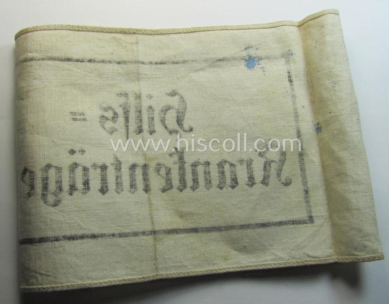 Neat, beige/white-coloured- and/or linnen-based armband (ie. 'Armbinde') as was executed in the 'thicker-styled' fabric as was intended for WH (Heeres) staff-members working as: 'Hilfs-Krankenträger'