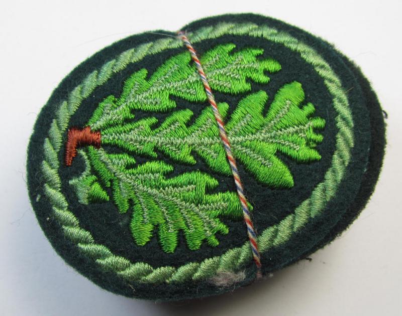 Attractive example of a WH (Heeres) so-called: 'Jäger'-armbadge, being a neatly machine-embroidered- and/or multi-coloured version as was executed on darker-green-coloured wool