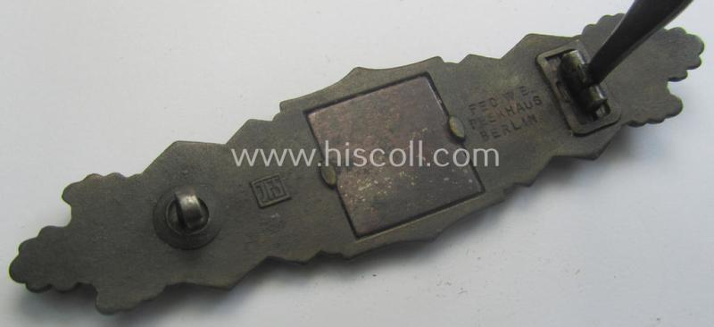 'Nahkampfspange in Bronze' (or: bronze-class close-combat clasp ie. CCC) being a neatly maker-marked- and/or minimally converse-shaped specimen as was produced by the: 'JFS'- (ie. 'Joseph Feix u. Söhne'-) company