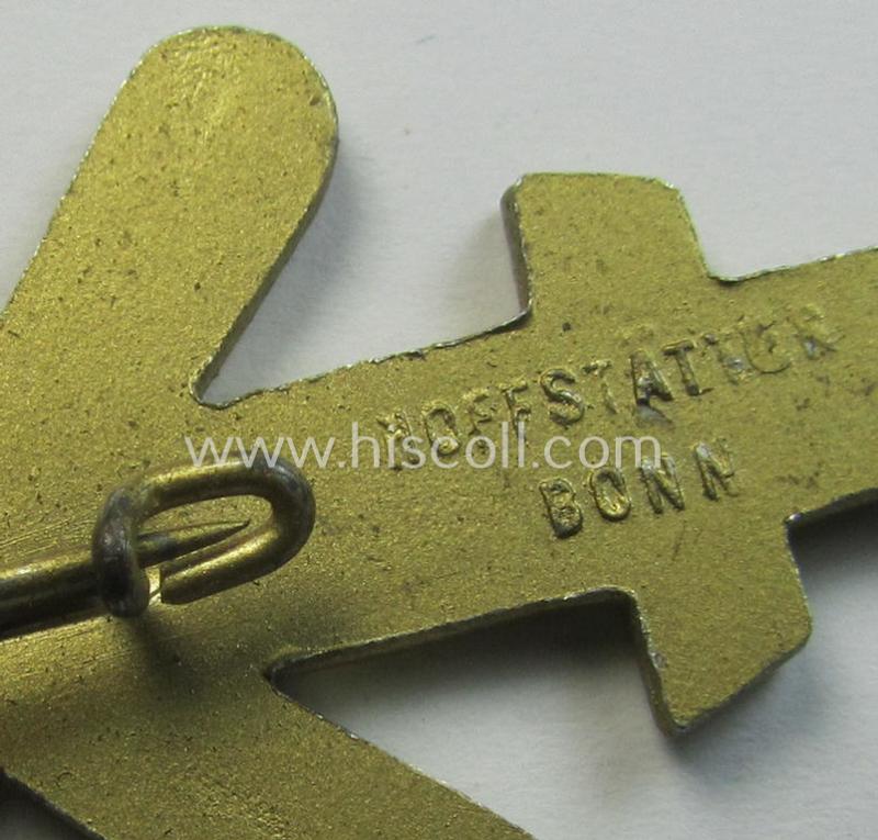 Commemorative, golden-coloured, N.S.D.A.P.-related 'tinnie' being a maker- (ie. 'Hofstätter - Bonn'-) marked example depicting a detailed, upright-positioned sword and two 'hammers' and swastika and bearing the dates: '1925 - 1935'