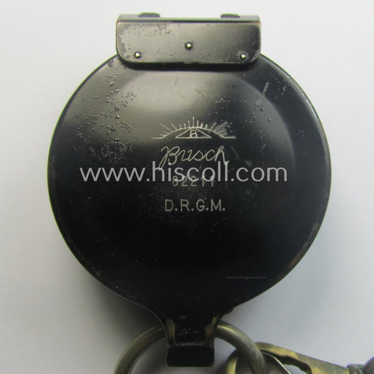 'Standard-issue'-pattern, black-coloured and/or copper-based WH-compass (ie. 'Marschkompass') which is nicely 'Busch- ie. D.R.G.M.'-marked and/or individually numbered: '82211' and that came mounted onto its period 'Fangschnur'