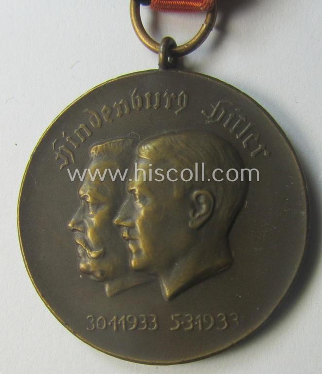 Darker-bronze-toned commemorative-medal (ie. 'Erinnerungs-Medaille') entitled: 'Hindenburg - Hitler - 30.1.1933 - 5.3.1933' and that comes mounted onto its period ribbon showing an interwoven swastika-device