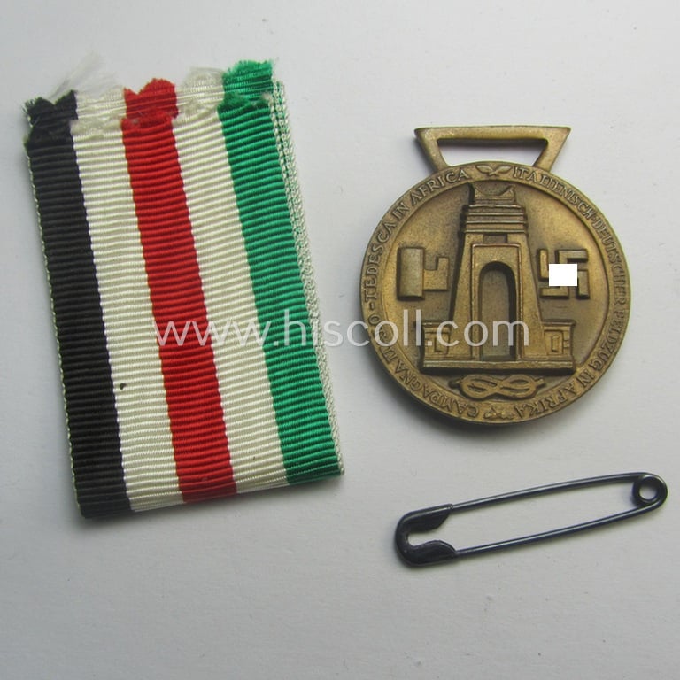 Golden-bronze-coloured (and 'Buntmetall'-based!) example of a: 'Deutsch-Italienische Feldzugsmedaille' (or: German-Italian campaign-medal) that came together with its (full length- and 'virtually mint- ie. unissued') piece of original ribbon