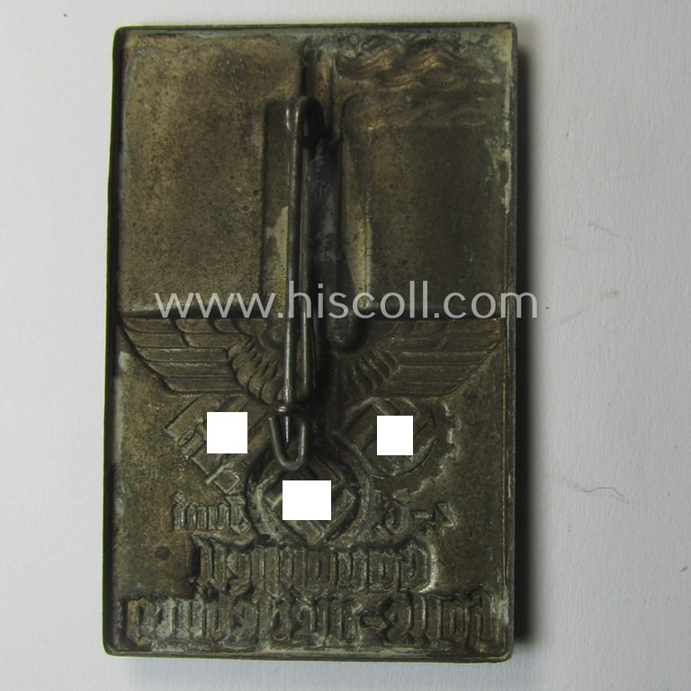 Commemorative, silver-toned- and DAF- (ie. 'Deutsches Arbeitsfront'-) related 'tinnie', being a non-maker-marked example depicting a factory-building, two logos and eagle-device coupled with the text: 'Gauappell - Halle Merseburg - 4.-6. Juni'