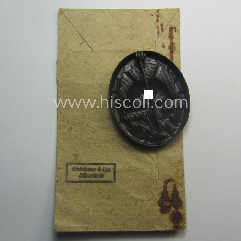'Verwundeten-Abzeichen in Schwarz' being a maker- (ie. '4'-) marked example by the: 'Steinhauer & Lück'-company that came stored in its (scarcely seen!) period pouch