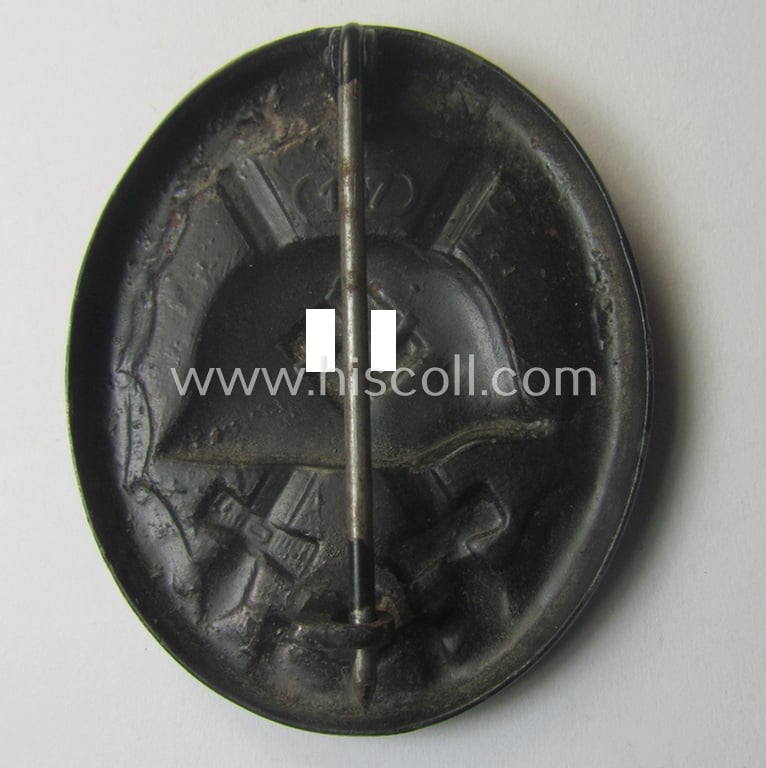 Moderately used - and neatly maker- (ie. '107-) marked - example of a black-class wound-badge (or: 'Verwundeten-Abzeichen in Schwarz') being an example that was produced by the maker (ie. 'Hersteller') named: 'Carl Wild'