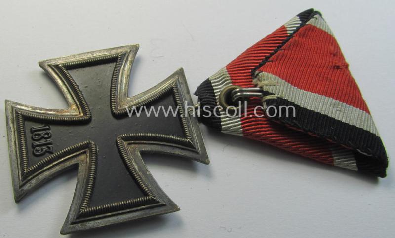 Neat, Iron Cross 2nd class (or: 'EK II. Klasse') being a non-maker-marked example that comes mounted onto its original (Austrian-styled!) ribbon (ie. 'Bandabschnitt') as was (I deem) produced by the (Austrian-based) company named: 'Rudolf Souval...