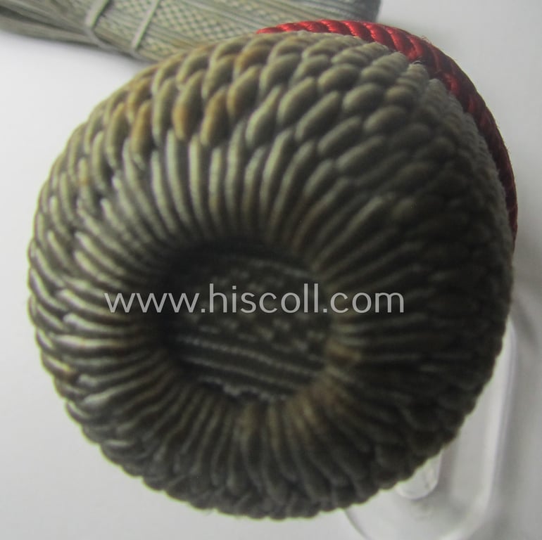 Bright-white-, red- and/or silver-coloured, EM- (ie. NCO-) type side-arm knot (ie. 'Portepee' ie.: 'Troddel') as was used for the various WH-bayonets and that comes in an overall very nice- (ie. 'virtually mint- ie. unissued'-), condition