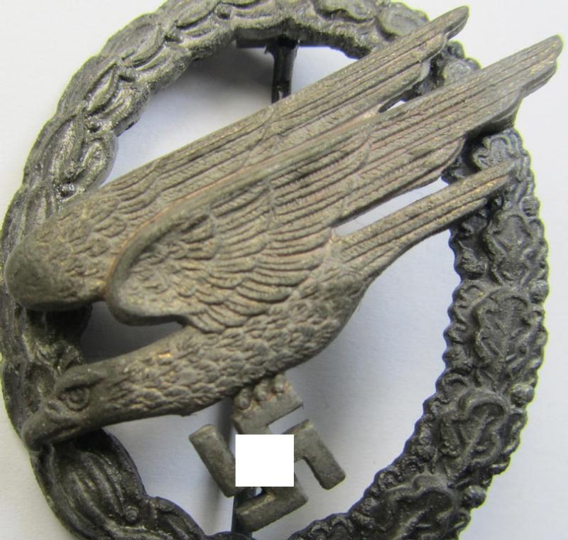 Attractive - and later-war-period! - zinc- (ie. 'Feinzink'-) based version of a WH (Luftwaffe) 'Fallschirmschützen-Abzeichen' being a clearly maker- (ie. 'A'-) marked example as was produced by the: 'Assmann'-company