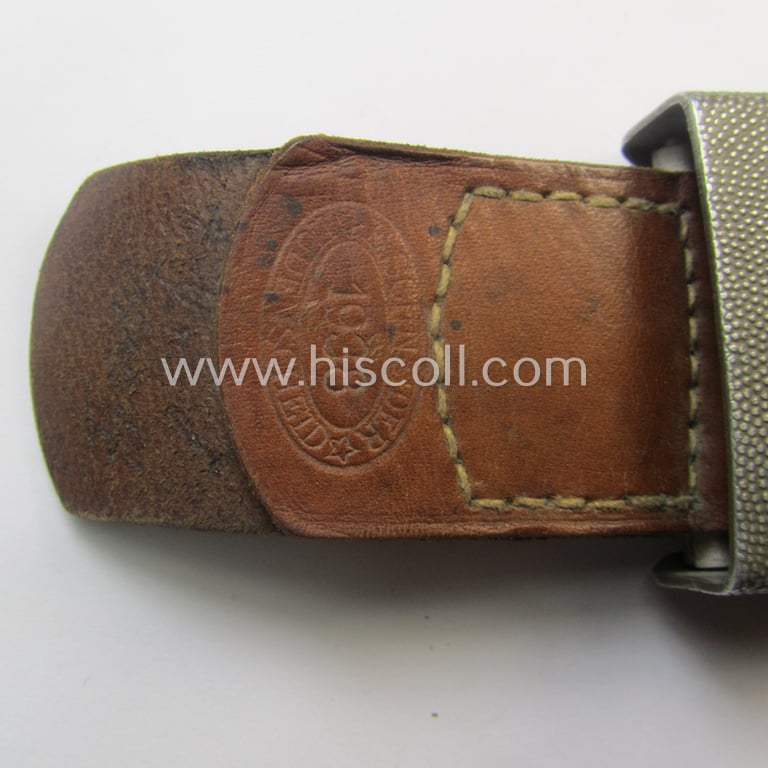 WH (Heeres) 'standard-pattern', field-grey-toned- and aluminium-based belt-buckle being a maker- (ie. 'E. Schneider - Lüdenscheid'-) marked- and/or: '1938'-dated example that comes mounted onto its leather-based tab