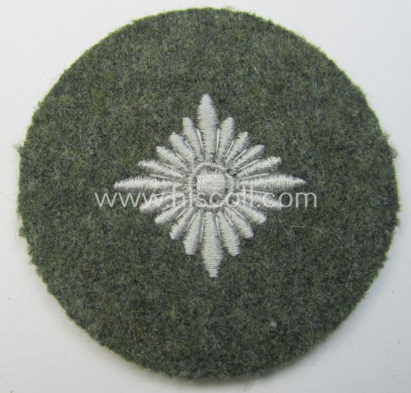 WH (Heeres) rank-insignia (ie. silver-grey-coloured and machine-embroidered 'roundel') as intended to identify a soldier with the rank of: 'Oberschütze', 'Oberjäger' etc. that comes in a 'virtually mint- ie. unissued', condition