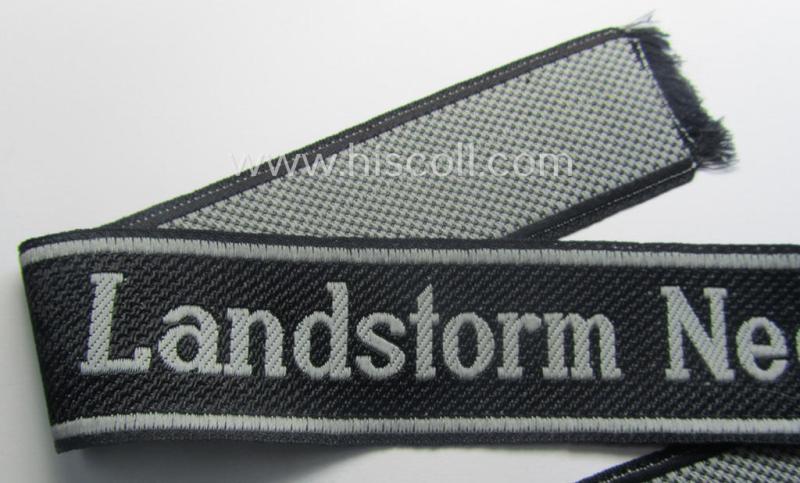 Waffen-SS, 1943/44 pattern cuff-title (ie. 'Ärmelstreifen') depicting the machine-woven Latin script text in silver-grey linnen as was intended for a member of the: '34. SS-Freiwilligen-Grenadier-Division': “Landstorm Nederland”