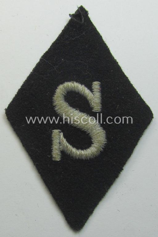 Waffen-SS-pattern, machine-embroidered and black-coloured sleeve-insignia (ie. 'Ärmelraute') depicting a captital: 'S'-character as was used to signify the function of: 'Schirrmeister' within the: 'Waffen-SS'