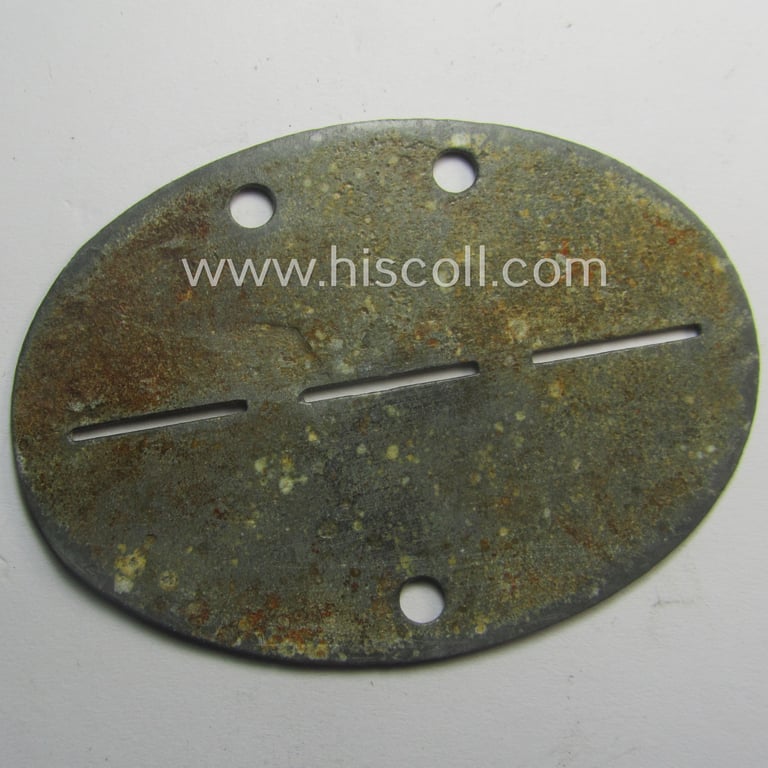 Interesting, zinc-based WH (Luftwaffe) ie. 'LW-Heimatflak-Artillerie'-related ID-disc (ie. 'Erkennungsmarke') bearing the stamped unit-designation that simply reads: 'Mittl. Heimatflakbattr. 1/VII' and that comes as issued- and/or worn