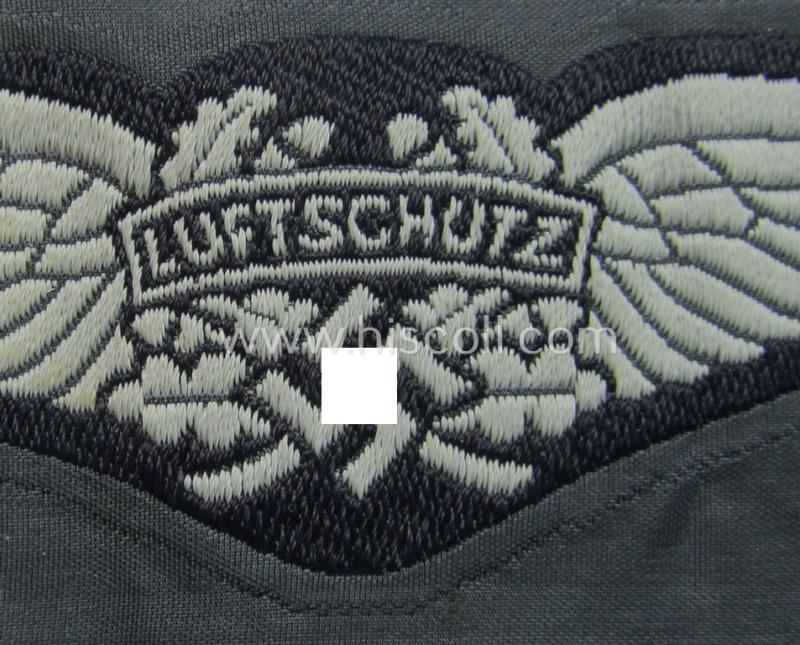Attractive - and scarcely encountered! - EM- (ie. NCO-) pattern, so-called: 'Luftschutz' (ie. RLB-) cap-badge (ie. 'Mützenabzeichen') as executed in so-called: 'BeVo'-weave-pattern and that comes in a 'virtually mint- ie. unissued' condition