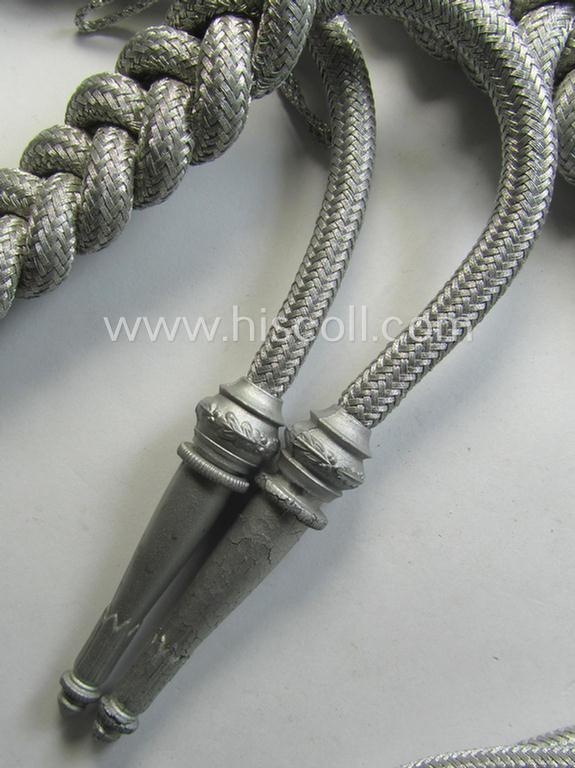 Bright-silver-toned, WH (Heeres): 'Paradefangschnur für Adjutanten' (ie. adjutants'-aiguillette) that comes stored in its period, carton box as issued