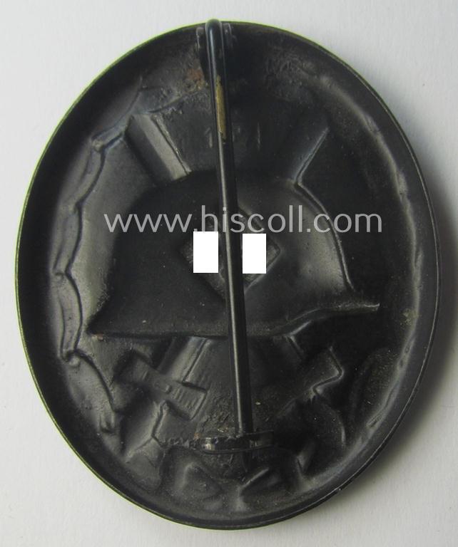 Nicely maker- (ie. '107-) marked example of a black-class wound-badge (or: 'Verwundeten-Abzeichen in Schwarz') being an example that was produced by the maker (ie. 'Hersteller') named: 'Carl Wild'