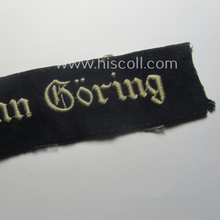 Truly used and typical 'smooth-woolen'-based, EM- (ie. NCO-) pattern WH (Luftwaffe) cuff-title (ie. 'Ärmelstreifen') entitled: 'Hermann Göring' that comes in a period-shortened and worn condition