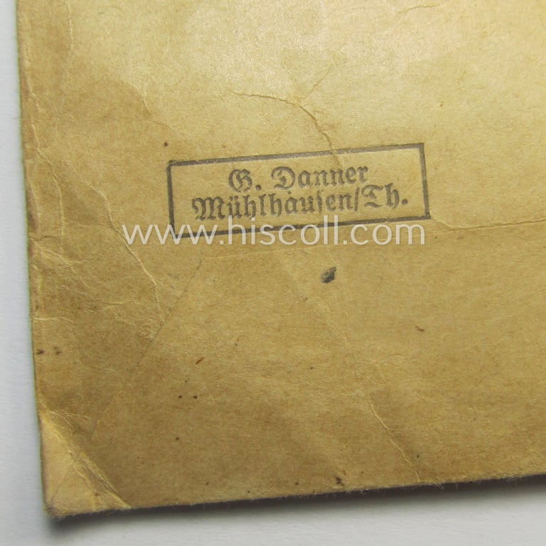 'Ehrenkreuz der deutschen Mutter - dritte Stufe' (or: bronze-class mothers'-cross) that came together with its long-sized ribbon and that came stored in its period pouch by the maker: 'G. Danner - Mühlhausen/Th.'