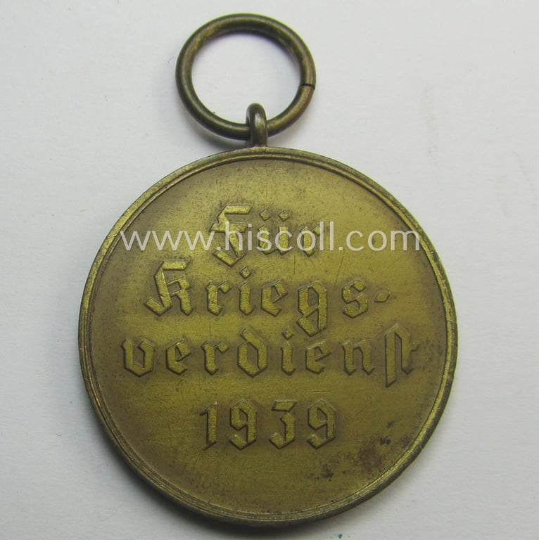 'Kriegsverdienstmedaille 1939' being a non-maker-marked- (and/or: typical 'Fenzink'-based) specimen that came together with its confectioned and shortened ribbon (ie. 'Bandabschnitt')