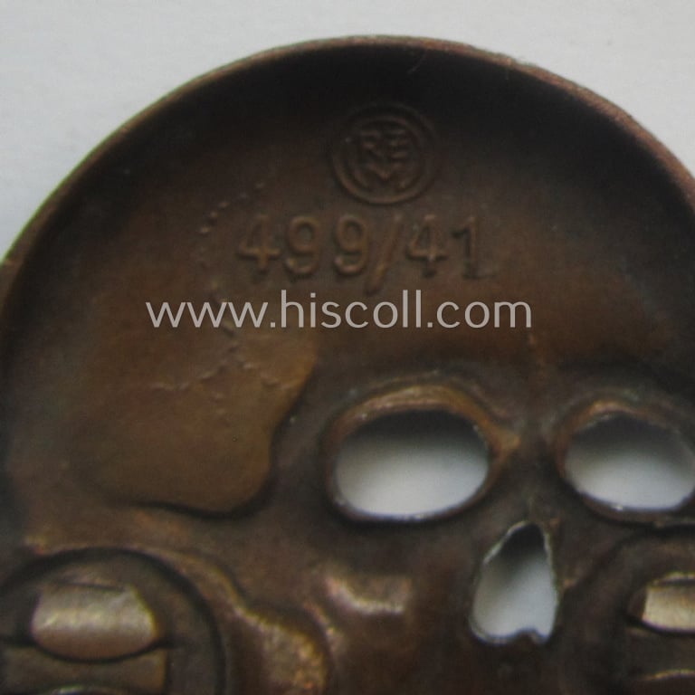 Superb - albeit regrettably incomplete but nevertheless rarely encountered! - 'Waffen-SS' visor-cap skull (ie. 'Totenkopf für Schirmmütze') being a detailed- and/or maker- (ie. 'RzM 499/41'-) marked example