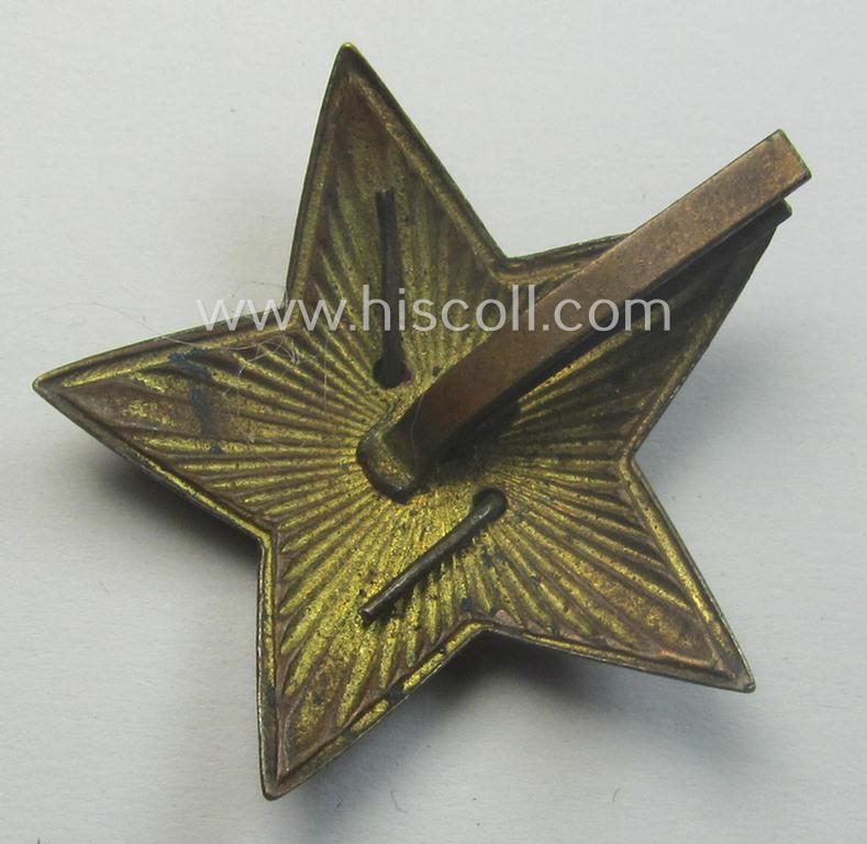 Unusal item that originated from a German soldier: a Russian, larger-sized and/or WWII-period, enamelled star-shaped cap-badge showing the communist logo on a bright-red-coloured surface