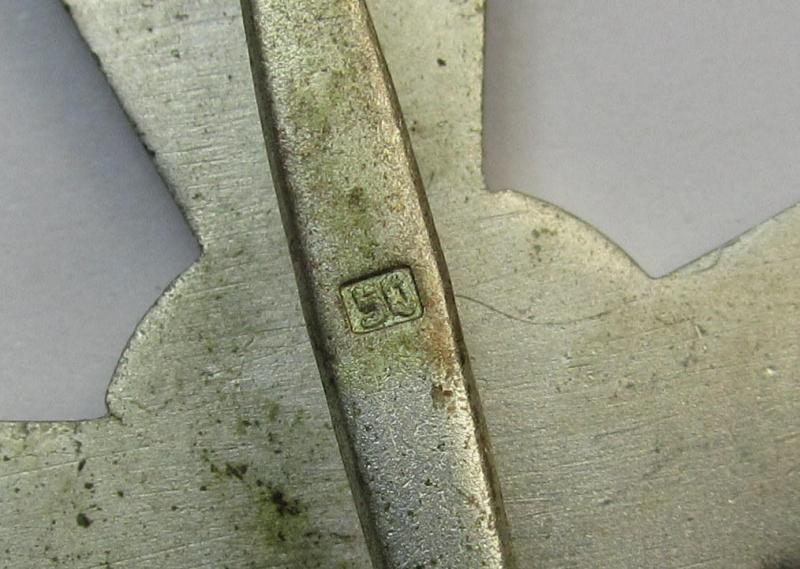 Luxuriously-styled, 'Kriegsverdienstkreuz 1. Klasse ohne Schwertern' being an attractive and maker- (ie. '50'-) marked specimen that is executed in typical, silverish-coloured metal (ie. 'Buntmetall') and that comes in a moderately used conditi...