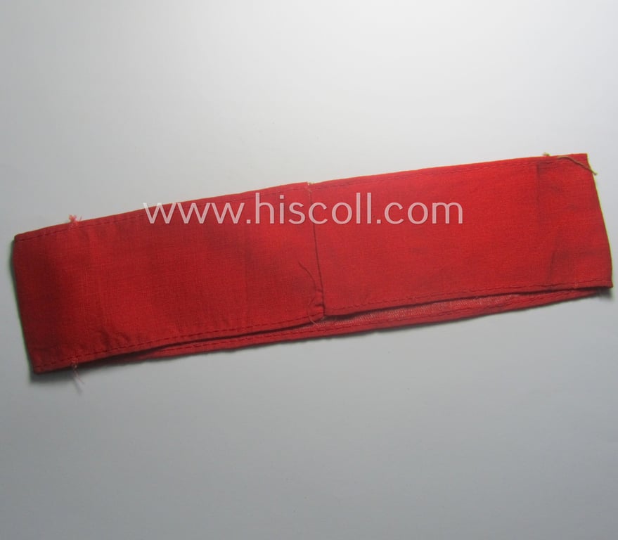 Truly worn, thin-shaped, 'N.S.D.A.P.'-related armband (ie. 'Armbinde') being of the 'entirely printed'-type showing a swastika-sign