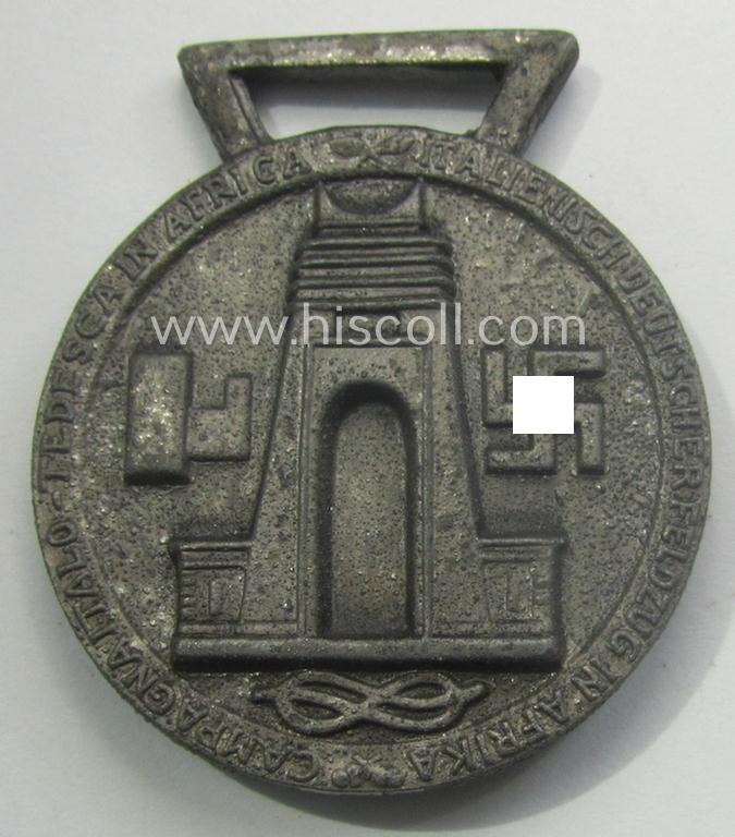 Silverish-bronze-coloured (and zinc-based!) example of a: 'Deutsch-Italienische Feldzugsmedaille' (or: German-Italian campaign-medal) that came together with its (full length- and virtually mint- ie. unissued) piece of original ribbon
