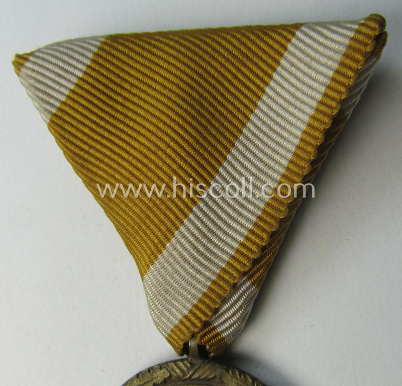 Interesting medal-set: 'Deutsches Schutzwall Ehrenzeichen' (aka: 'Westwall'-medal) being a non-maker-marked- (and/or: typical 'Buntmetall'-based) specimen that came mounted onto its (scarcely seen!) Austrian-styled and trapezoid-folded ribbon