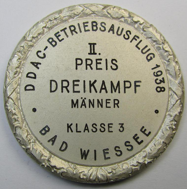 Interesting, D.D.A.C.-related, commemorative plaque (ie. 'Erinnerungs- o. nichttragbare Auszeichnungsplakette') showing an illustration of a sportsman and on its back the text: 'II. Preis Dreikampf Männer 1938' and that comes stored in its period...