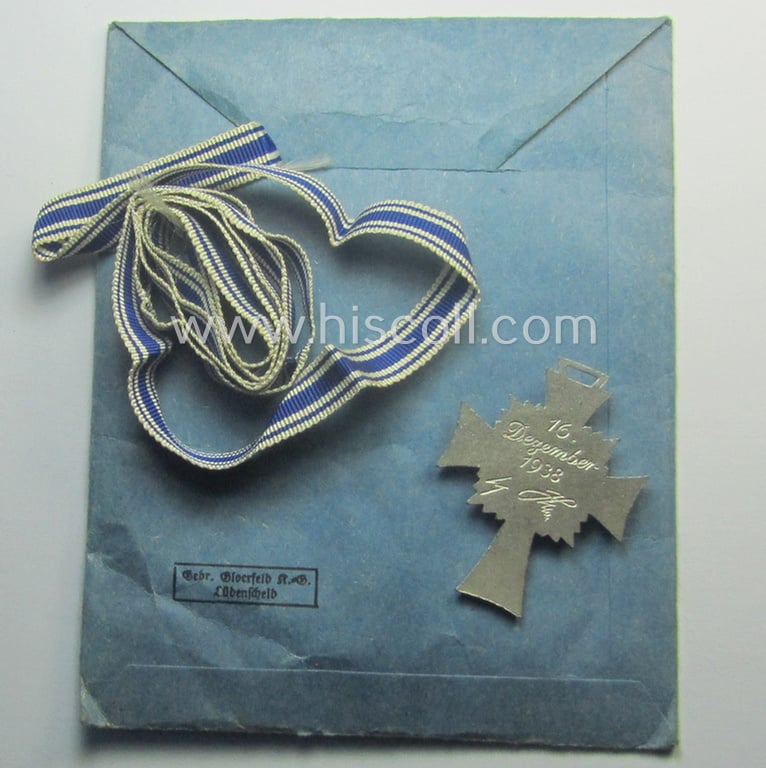 'Ehrenkreuz der deutschen Mutter - zweite Stufe' (or: silver-class mothers'-cross) that with its long-sized ribbon and that came stored in its period pouch by the (unusually seen!) maker: 'Gebr. Gloerfeld K.G. - Lüdenscheid'