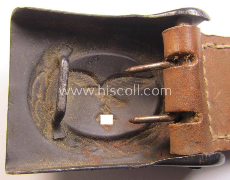 WH (Luftwaffe) bluish-grey-coloured, steel-based belt-buckle, being a maker- (ie. 'H. Aurich'-) marked- and/or: '1942'-dated example that comes mounted onto its leather-based tab and that comes in a 'virtually mint' condition