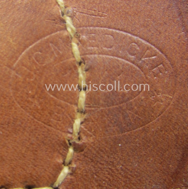 WH (Heeres) field-grey-coloured- and/or steel-based belt-buckle, being a maker- (ie. 'J. C. Maedicke'-) marked- and/or: '1941'-dated example that comes mounted on its leather-based tab and that comes in a moderately used- ie. worn, condition