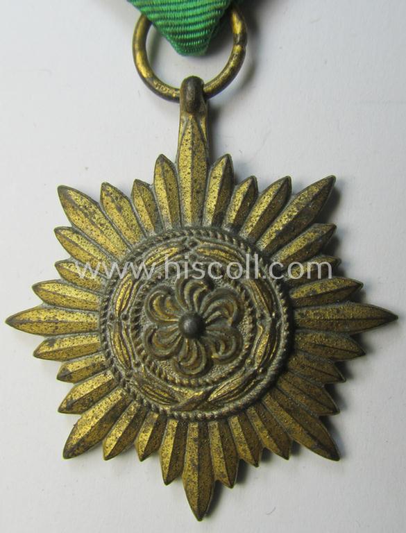 WH-related so-called: 'Verdienstauszeichnung für Angehörige der Ostvölker, 2. Klasse in Gold ohne Schwerter', being a nicely maker- (ie. '100'-) marked- and/or: 'Feinzink'-based example that comes mounted on its period ribbon