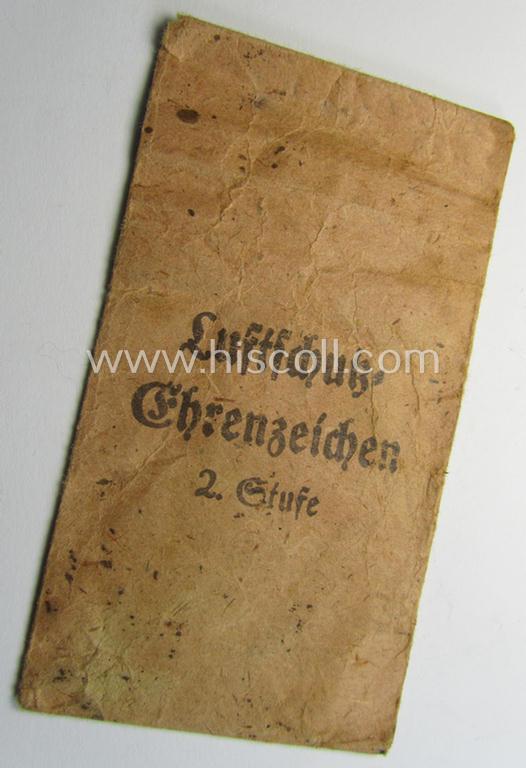 'Luftschutz-Ehrenzeichen 2. Stufe' being a non-maker-marked example, as executed in zinc-based metal (ie. 'Feinzink') and that comes stored in its (scarcely seen!) 'Zellstoff'-based pouch by the maker: 'Katz u. Deyhle'