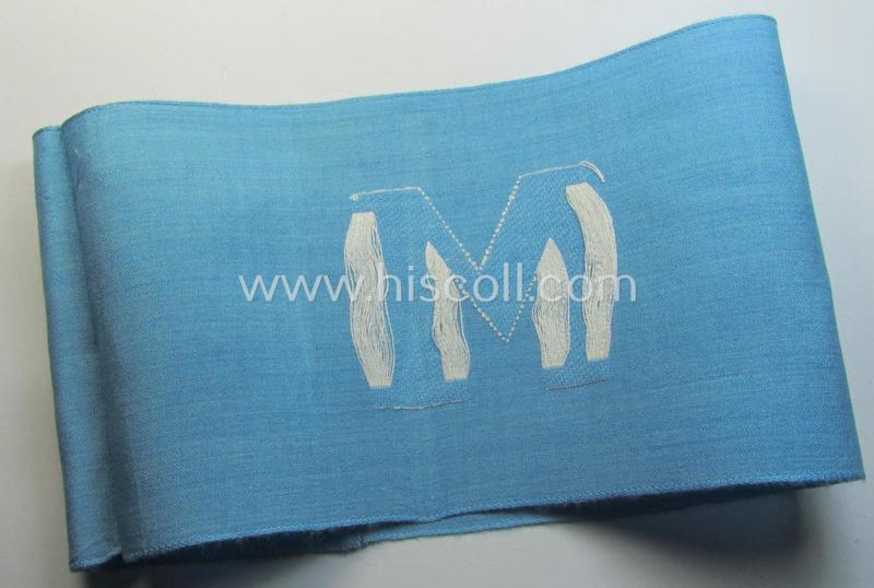 Attractive, linnen-based- and/or light-blue-coloured armband (ie. 'Armbinde') depicting an interwoven capital 'M'-character as was presumably intended for staff-members of the German RLB (ie. 'Reichsluftschutz-Bund')