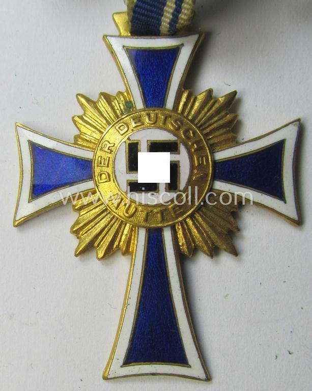 Attractive, 'Ehrenkreuz der deutschen Mutter - erste Stufe' (or: golden-class mothers'-cross) being a hardly used example that comes mounted onto its accompanying, long-sized ribbon as issued and/or recently found