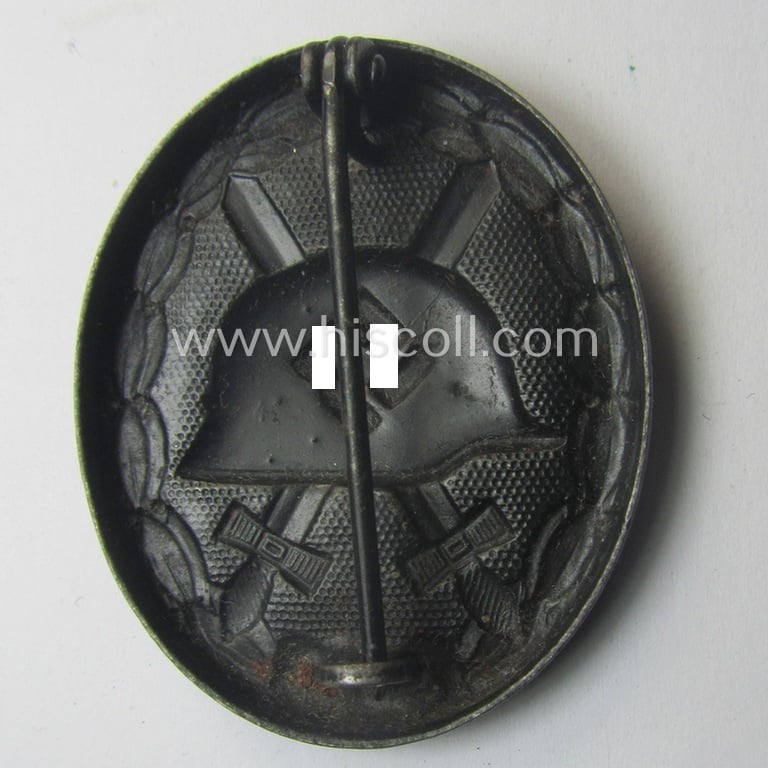 Black-class wound-badge (or: 'Verwundeten-Abzeichen in Schwarz') being a maker- (ie. '4'-) marked specimen as was produced by the maker (ie. 'Hersteller') named: 'Steinhauer & Lück'