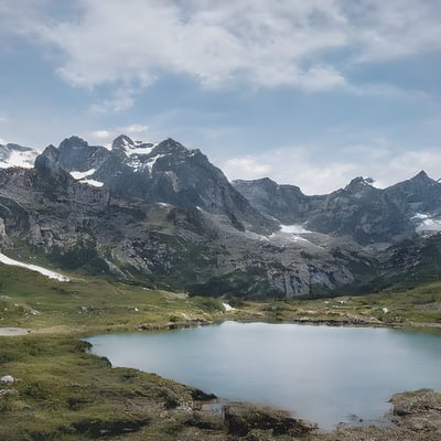 A mountain range with a lake in the foreground