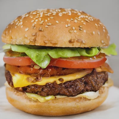 A hamburger with lettuce tomato and cheese