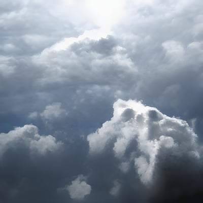 A plane flying through a cloudy blue sky