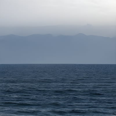 A large body of water with mountains in the background