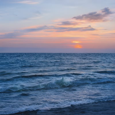 The sun is setting over the ocean waves