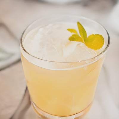 A close up of a drink in a glass on a table