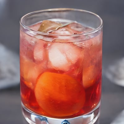 A close up of a drink in a glass on a table